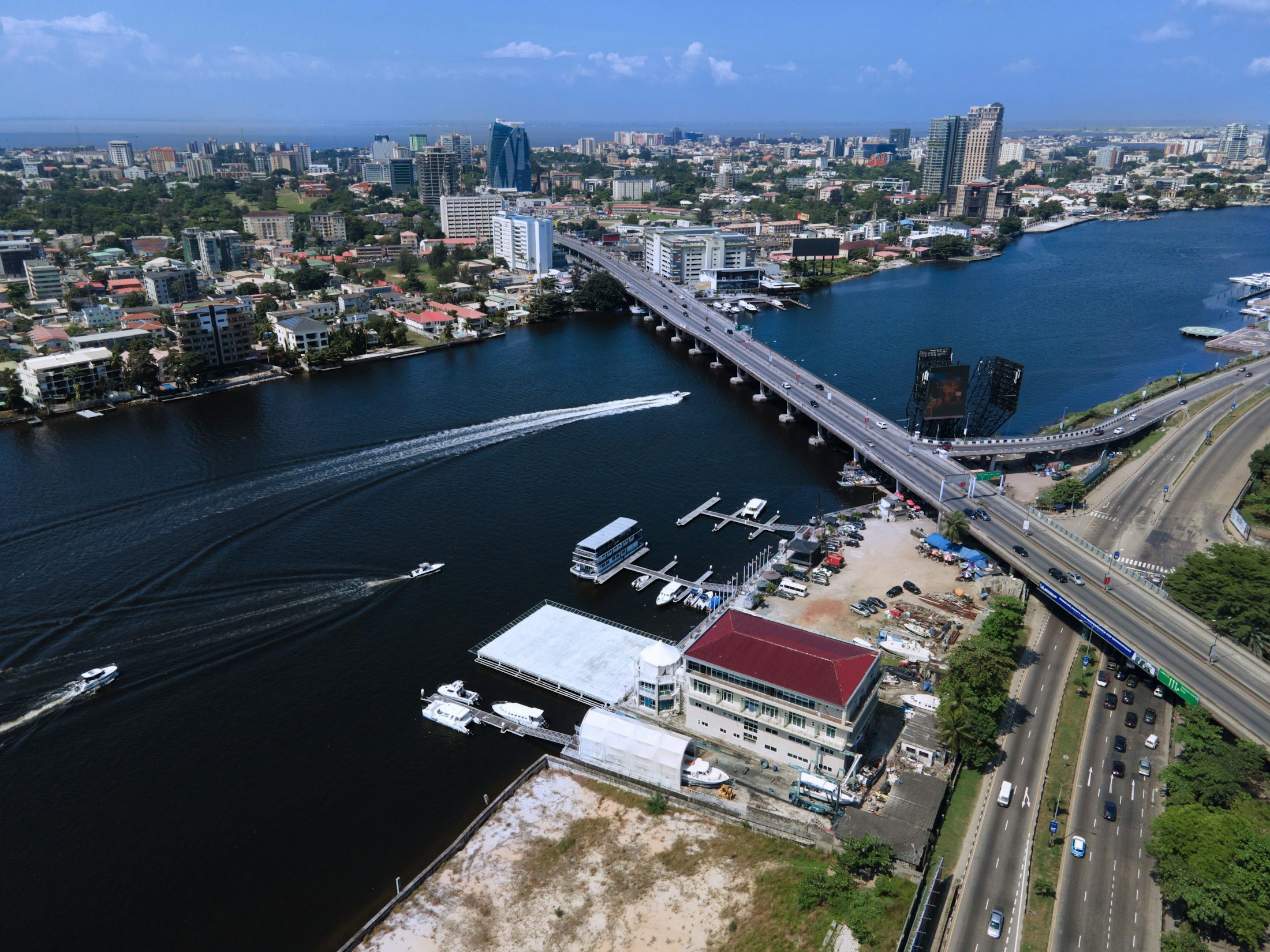 Aerial view of the Lagos lagoon, with a bridge, marina and residential neighbourhoods